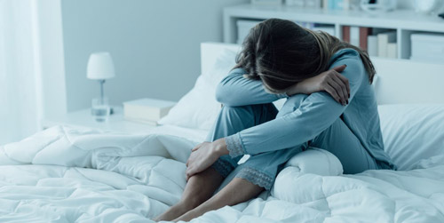 depressed woman on the bed